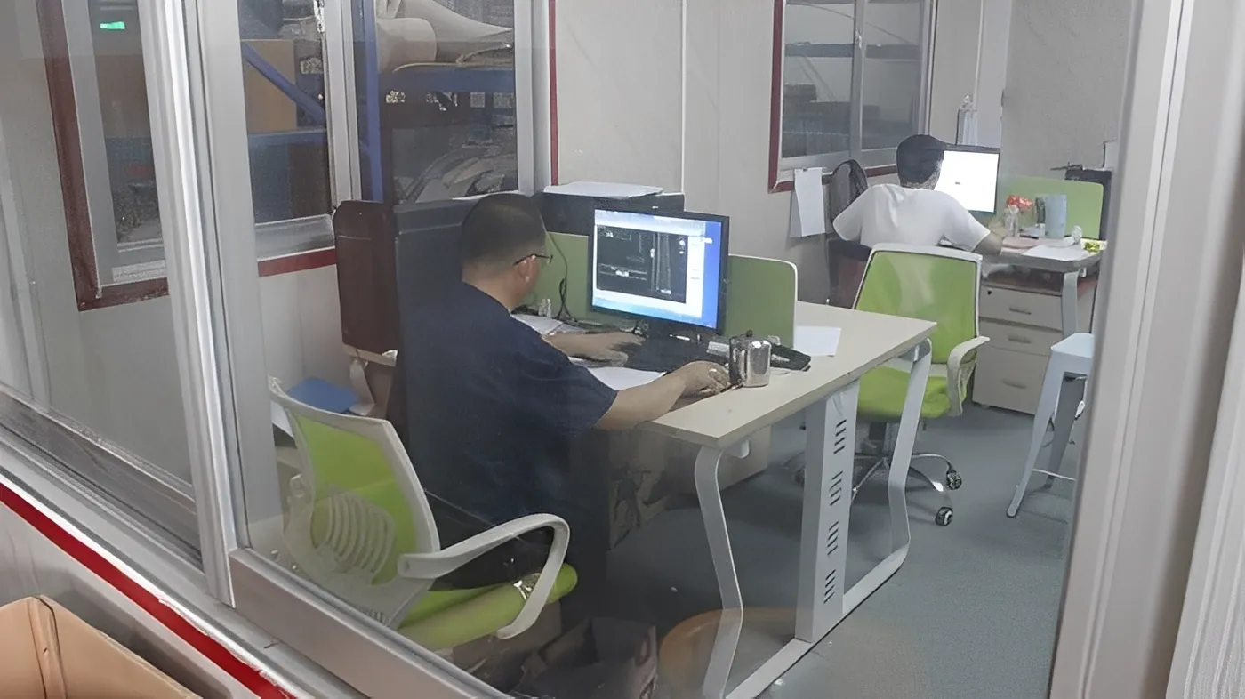 Design team consultation - engineers reviewing custom layout plans with customer