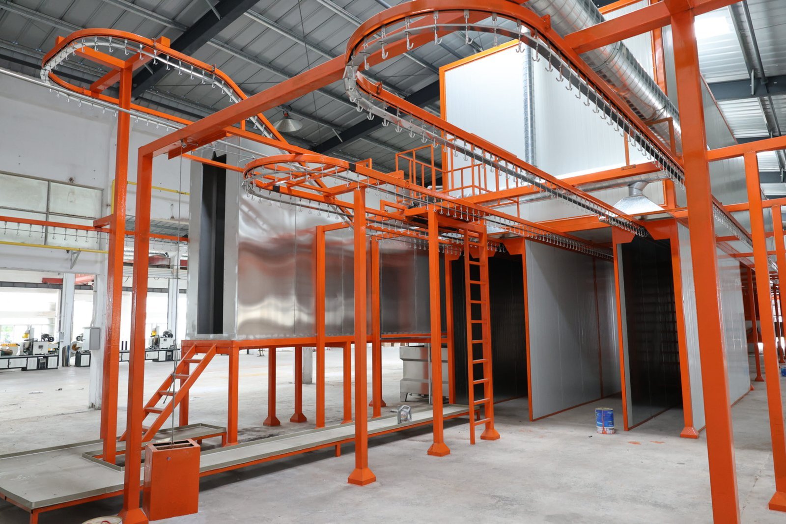 Pallet rack beams uprights and warehouse shelf frames entering powder spraying booth
